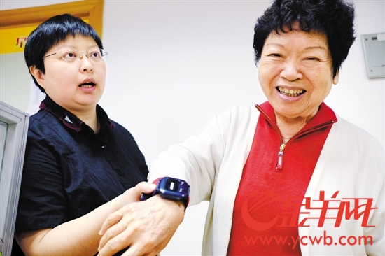 82岁的刘老师在越秀区社区服务中心开心领到平安宝